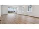 Spacious living area with modern floors, large sliding glass doors, and abundant natural light at 19110 E 96Th Pl, Commerce City, CO 80022