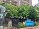 The Brooks Tower building entrance is set behind greenery, with a modern statue out front at 1020 15Th St # 18I, Denver, CO 80202