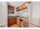 A kitchen with wooden cabinets, stainless steel appliances, and hardwood floors at 1020 15Th St # 18I, Denver, CO 80202