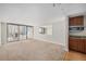 A living room with a view of the city, carpeted floors, and a combined kitchen at 1020 15Th St # 18I, Denver, CO 80202