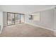 An empty living room featuring carpet, a large window, and a view of the city at 1020 15Th St # 18I, Denver, CO 80202