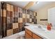 This bathroom features wood cabinets, a sink, a shower and a toilet at 11565 Decatur St # 7D, Denver, CO 80234
