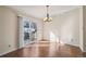 Bright dining area featuring a chandelier and sliding glass door leading to the backyard at 11565 Decatur St # 7D, Denver, CO 80234