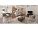 Open concept kitchen and living room with a large area rug and recessed lighting at 11565 Decatur St # 7D, Denver, CO 80234