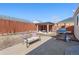 Backyard with a paved patio, grill, and a small shelter with a fire pit at 15627 E 51St Dr, Denver, CO 80239