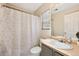 Well-lit bathroom with a toilet, sink, and shower with modern fixtures at 15627 E 51St Dr, Denver, CO 80239