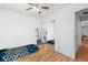 Clean bedroom with a ceiling fan and a sliding mirrored closet at 15627 E 51St Dr, Denver, CO 80239