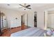 Cozy bedroom with wood floors, ceiling fan, and a doorway to the Primary closet at 15627 E 51St Dr, Denver, CO 80239