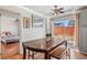 Dining area with access to backyard via sliding glass door, adjacent to kitchen and with ceiling fan at 15627 E 51St Dr, Denver, CO 80239