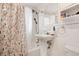 Bright bathroom with a classic pedestal sink and white tile at 4961 E Cornell Ave, Denver, CO 80222