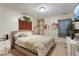 Cozy bedroom featuring carpet, decorative wall hangings, and a comfortable bed with plush pillows and a light green throw blanket at 4961 E Cornell Ave, Denver, CO 80222