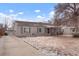 Charming single-story home with a well-maintained front yard and private driveway on a sunny day at 4961 E Cornell Ave, Denver, CO 80222