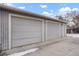 Three car garage with gray doors and siding, offering ample parking and storage space at 4961 E Cornell Ave, Denver, CO 80222