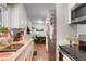 Galley kitchen with granite countertops and stainless steel appliances at 4961 E Cornell Ave, Denver, CO 80222