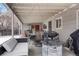 Covered outdoor patio with lounge seating, a dining table, and a fire pit, great for entertaining and relaxation at 4961 E Cornell Ave, Denver, CO 80222