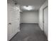 Unfinished basement with gray painted concrete flooring and access to multiple doors at 4947 Noble Park Pl, Boulder, CO 80301