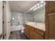 Bathroom features a shower/tub combo, a large mirror, and a wood vanity at 4947 Noble Park Pl, Boulder, CO 80301
