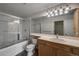 Bright bathroom features a tub/shower combo, a large mirror, and ample counter space at 4947 Noble Park Pl, Boulder, CO 80301