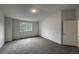 Bright bedroom features a large window, neutral carpeting, and white walls at 4947 Noble Park Pl, Boulder, CO 80301