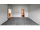 Expansive bedroom features neutral carpet, white walls, and two doorways to other rooms at 4947 Noble Park Pl, Boulder, CO 80301
