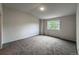 Spacious bedroom is well-lit and features a large window and neutral carpet at 4947 Noble Park Pl, Boulder, CO 80301