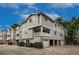 Three-story condo with siding and brick, featuring garage parking and front patio at 4947 Noble Park Pl, Boulder, CO 80301