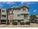 Multi-level condo with brick and siding, showcasing covered balconies and attached garages at 4947 Noble Park Pl, Boulder, CO 80301
