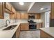 Well-lit kitchen features stainless steel appliances, tile flooring, and plentiful cabinet space at 4947 Noble Park Pl, Boulder, CO 80301