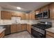 Bright kitchen showcases stainless steel appliances, light countertops, and ample wood cabinetry at 4947 Noble Park Pl, Boulder, CO 80301