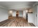 Open living space featuring wood floors and fireplace, flowing into the kitchen and other areas at 4947 Noble Park Pl, Boulder, CO 80301