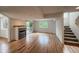 Bright living room with hardwood floors, a fireplace, and access to an outdoor space at 4947 Noble Park Pl, Boulder, CO 80301