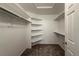Walk-in closet features carpeted flooring, ample shelving, and plentiful rod space at 4947 Noble Park Pl, Boulder, CO 80301