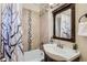 Bathroom with tiled walls, decorative accent tiles, modern sink and vanity, and shower with curtain at 2222 N Williams St, Denver, CO 80205