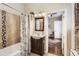 Bathroom featuring a vanity sink, decorative seashell shower curtain, and adjacent bedroom at 2222 N Williams St, Denver, CO 80205