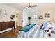 Cozy bedroom with hardwood floors, ceiling fan, closet, and comfortable bed with decorative pillows at 2222 N Williams St, Denver, CO 80205
