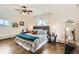 Bedroom with hardwood floors, ceiling fan, stylish bed, decorative pillows and large window at 2222 N Williams St, Denver, CO 80205