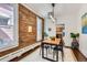 Dining area with brick wall and a modern lighting fixture and hardwood flooring at 2222 N Williams St, Denver, CO 80205