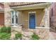 Close-up of the house front showing the blue door and flowers on the front porch at 2222 N Williams St, Denver, CO 80205