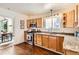 Bright kitchen with wood cabinets, granite countertops, stainless steel appliances, and wooden floors at 2222 N Williams St, Denver, CO 80205