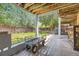 Back yard patio with a wheelbarrow and outdoor grill surrounded by mature trees and greenery at 540 Ithaca Dr, Boulder, CO 80305