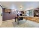 Finished basement office featuring a large window, built-in shelving, carpeted floors, and stylish décor at 540 Ithaca Dr, Boulder, CO 80305