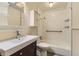 White tiled bathroom with shower-tub combination and modern vanity at 540 Ithaca Dr, Boulder, CO 80305