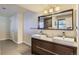 Modern bathroom featuring a double sink vanity, large mirror, and tile flooring at 540 Ithaca Dr, Boulder, CO 80305