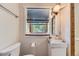 Bright bathroom featuring a modern sink, toilet, mirror and window at 540 Ithaca Dr, Boulder, CO 80305