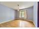 Bedroom with light purple walls, hardwood floors, and a window with curtains at 540 Ithaca Dr, Boulder, CO 80305
