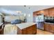 Spacious kitchen featuring stainless steel appliances, an island with seating, that opens up to the living room at 540 Ithaca Dr, Boulder, CO 80305