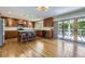 Bright kitchen with hardwood floors, an island with seating, stainless appliances, and access to the outdoor deck at 540 Ithaca Dr, Boulder, CO 80305