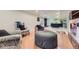 Open concept room with hardwood floors, comfortable seating and wet bar in the background at 540 Ithaca Dr, Boulder, CO 80305