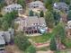 Spacious home featuring a large backyard with a pool, outdoor seating, and mature trees at 4 White Fir Ct, Littleton, CO 80127