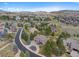 Serene aerial view of a home showcasing its prime location, circular drive, and mountain views at 4 White Fir Ct, Littleton, CO 80127
